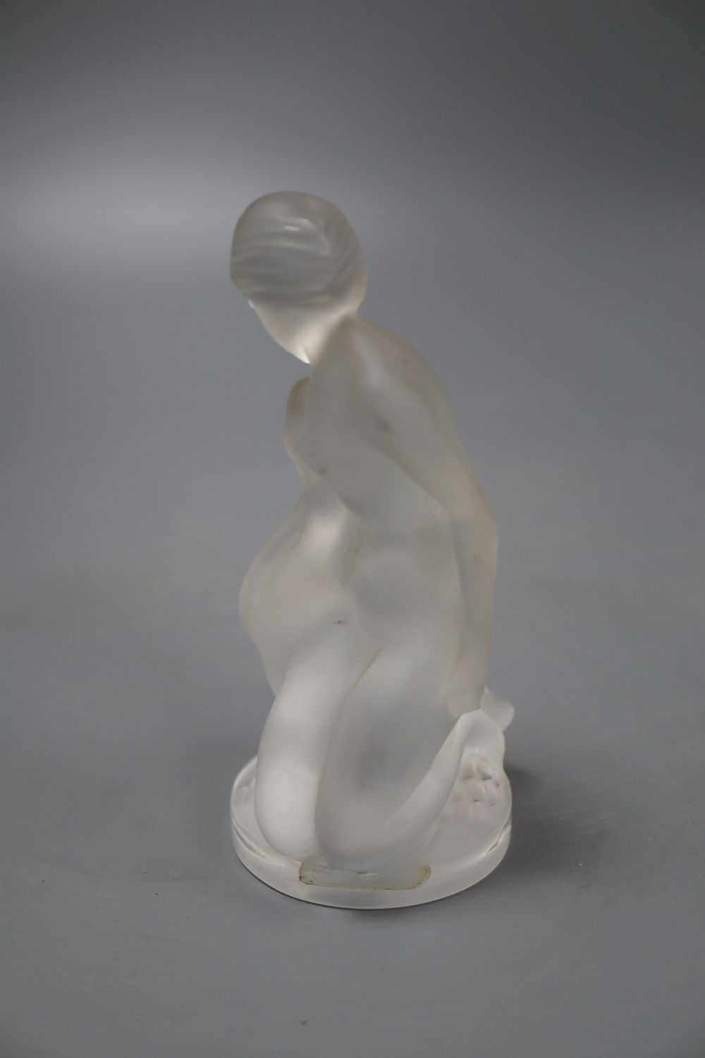 A Lalique figure of a lady and a swan, height 12cm